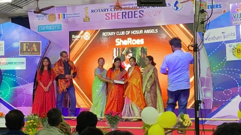 People on stage presenting a certificate at a community event.